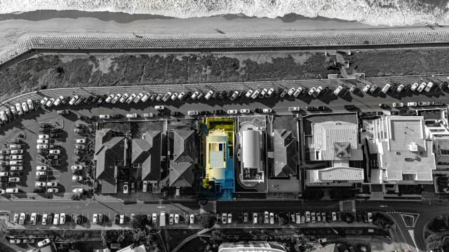 Bird's-eye aerial view of a beachfront residential property beside the Cronulla coastline and beach in NSW.